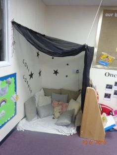 a child's play room with a bed and stuffed animals