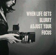 a woman holding a camera with the words when life gets blurry adjust your focus