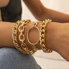 a close up of a person wearing gold bracelets