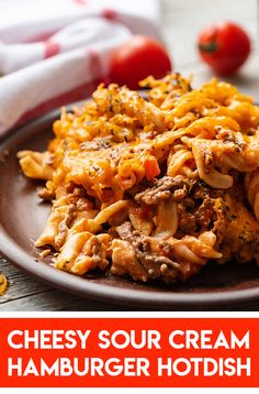 cheesy sour cream hamburger hot dish on a plate with tomatoes in the background