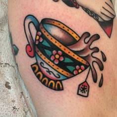 a tattoo with a tea cup and saucer on it