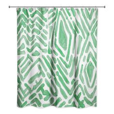 a green and white shower curtain with an abstract design on the bottom, in front of a