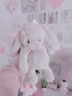 a white stuffed animal sitting on top of a table