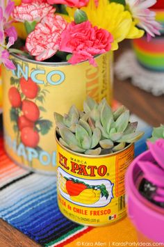 an image of flowers in tins on the table