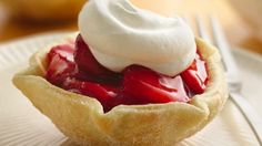 a strawberry pie with whipped cream on top