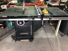 a table sawing machine sitting on top of a workbench