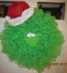 This Grinch Deco Mesh Christmas Wreath in in like-new condition.  The Santa hat makes this Grinch unique from the others.  It measures about 22 inches diameter. It will look great on your door, window or wall. We are a smoke-free and pet-free home. It will be carefully packaged to ensure damage free delivery. Deco Mesh Christmas Wreaths, Christmas Mesh Wreaths, Santa Hat, Hat Making, Door Wreath Hanger, Deco Mesh, Grinch, Door Hangers, Door Wreaths