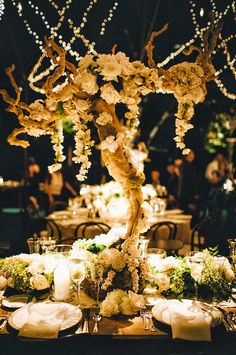 an image of a table setting with flowers and candles in the center, on instagram