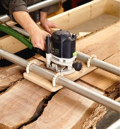 a man using a circular saw to cut wood with a machine on top of it