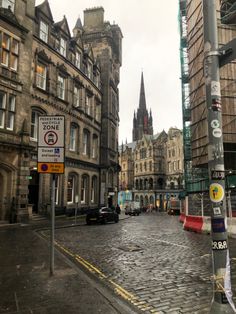 an old city street with tall buildings on both sides