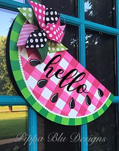 a watermelon door hanger with the word hello written on it