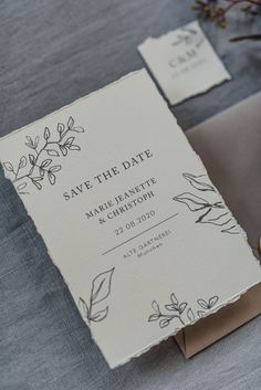 an elegant save the date card on top of a table