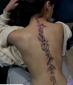 a woman with a tattoo on her back