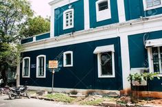 a blue building with white trim and windows