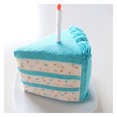 a blue birthday cake with a single candle on it's top, sitting on a plate