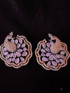 Premium Quality Peacock Victorian Style Earrings Pair with American Diamond with Black Polish with Pink Water Stones Item : Earring Set Color : Black and PinkLength of Earrings : 1.5 inches Width of Earnings - 1.5 inches Shop Polices -- Final Sale, No Return, No exchange - Please note Jewelry is delicate and Fragile, please handle with care.- There can be little variation in the color due to screen resolution setting, phone display setting or anything else. Kindly do not hold us responsible.- No return or exchange will be accepted for color variations.- In case of any issue please reach us within 3 days of delivery. Elegant Peacock Colored Earrings For Wedding, Elegant Peacock Earrings For Wedding, Party Earrings In Peacock Color, Peacock Design Jewelry For Party, Peacock Colored Earrings For Wedding, Silver Peacock Design Earrings For Party, Elegant Peacock Design Earrings For Party, Elegant Pink Jewelry With Peacock Design, Peacock Design Drop Earrings For Party