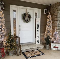 the front door is decorated with christmas trees and wreaths