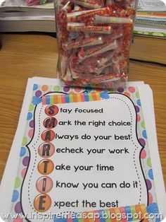 a jar filled with candy sitting on top of a table next to a sign that says,