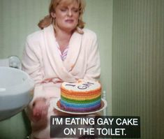 a woman sitting in front of a cake with the words i'm eating gay cake on the toilet