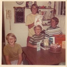 a group of people sitting around a wooden table