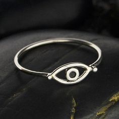 This sterling silver evil eye ring is perfect for stacking. While evil eye amulets were first recorded by the Mesopotamians about 5,000 years ago on clay tablets, belief in their protective power is still strong in many parts of the world. People attach an evil eye amulet to everything they wish to protect from envy an Evil Eye Ring Silver, Evil Eye Amulet, Seeing Eye, Pendant Bails, All Seeing Eye, Evil Eye Ring, Monogram Jewelry, Silver Bead Bracelet, Mini Charm