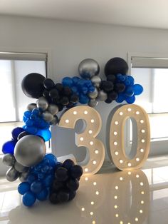 balloons are arranged around the number 30 sign