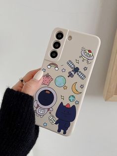 someone holding up their phone case with an image of cats and other things on it