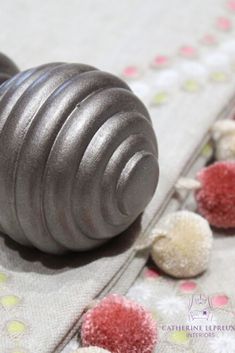 a metal object sitting on top of a table next to some candy canes and sprinkles