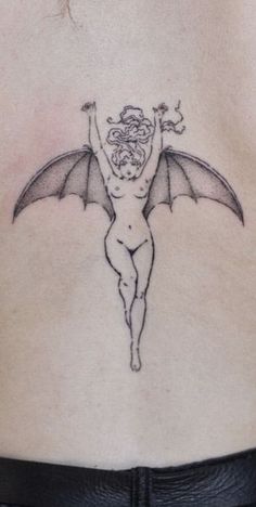 a woman with a bat tattoo on her back