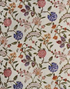 a white fabric with colorful flowers and leaves on the front, as well as an image of