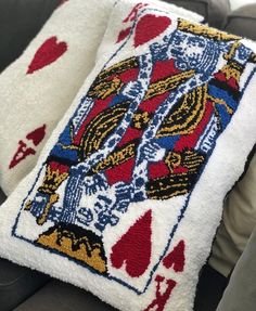 a pair of playing cards hooked up to a car headrest with two matching pillows