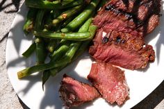 steak and green beans on a white plate