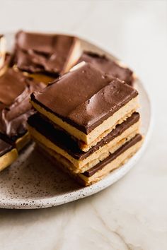 a plate topped with chocolate covered desserts on top of a table