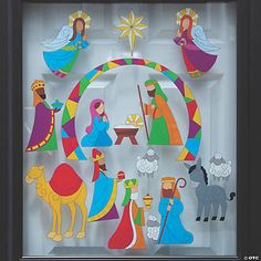 a shadow box with cutouts of christmas scenes in it