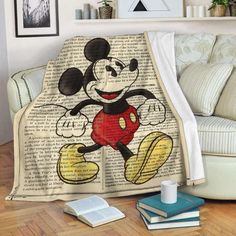 a mickey mouse blanket sitting on top of a couch