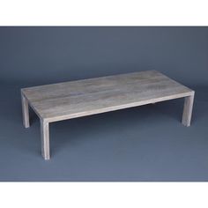 a wooden table sitting on top of a gray floor