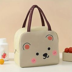 a white lunch bag with a bear face on it