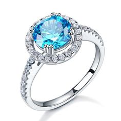 an oval blue topazte and diamond ring with white diamonds on the sides, set in