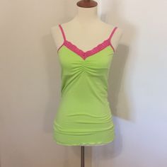 This Is A Brand New Love Tanjane Cami Top. Bright Green Color With Bright Pink Lace Trim. Adjustable Strap Length. Lightweight Built In Shelf Bra. Soft And Stretchy Material. Measures 13 Inches Across The Bust And Is About 26 Inches In Length. Made In Southern California. Price Is Firm. Thanks For Looking. Pink And Green Clothing, 2000s Fashion Colorful, Pink Stretch V-neck Camisole, Fitted Seamless V-neck Sleepwear, Pink Stretch Camisole For Loungewear, Green Spaghetti Strap Tops For Loungewear, Pink Stretch Sleeveless Sleepwear, Pink Stretch Flirty Tank Top, Pink Sleeveless Stretch Sleepwear