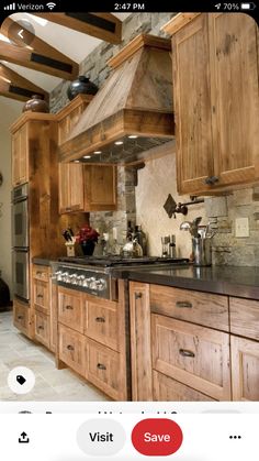 a kitchen with wooden cabinets and black counter tops, an oven and stove hood in the center