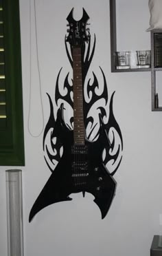 an electric guitar hanging on the wall