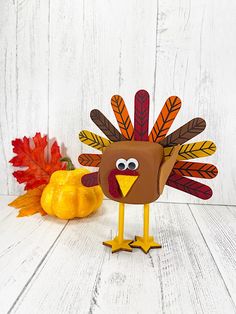 a paper turkey sitting on top of a white table