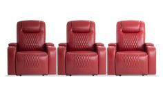 three red leather reclining chairs sitting next to each other