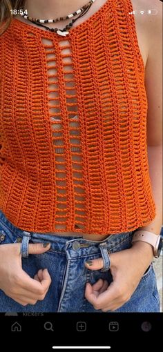 a woman wearing an orange knitted top