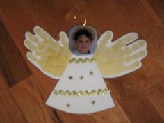 an angel ornament is shown on the floor with gold stars and beads around it