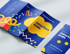 an open brochure is displayed on a white surface with blue and yellow colors