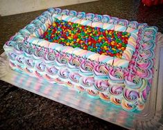 a large cake decorated with candy and sprinkles