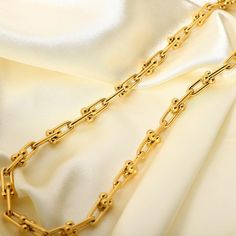 Featuring unique U-shaped links in 18k gold plating, this U Link Chain Necklace is a modern take on classic chain styles. Its contemporary design adds a chic edge to any ensemble. Luxury Gold Plated Chain Necklace With Solid Link, Luxury Gold-plated Chain Necklace With Solid Link, Modern Gold Plated Link Chain Necklace, Elegant Gold-plated Chain Necklace With Rectangular Links, Modern Gold Plated Paperclip Chain Necklace, Modern Gold-plated Paperclip Chain Necklace, Trendy Yellow Gold Link Chain Necklace, Elegant Gold Chain Necklace With Solid Link, Modern Gold Plated Chain Necklace With Chunky Chain