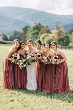 the bride and her bridesmaids pose for a photo