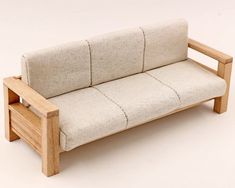 a small wooden couch sitting on top of a white floor